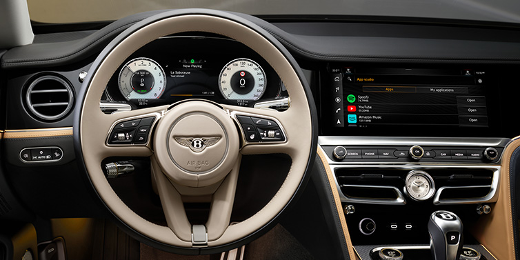 Bentley Sydney Bentley Flying Spur Mulliner sedan front interior detail of steering wheel and driver screens surrounded by Linen and Beluga black hides